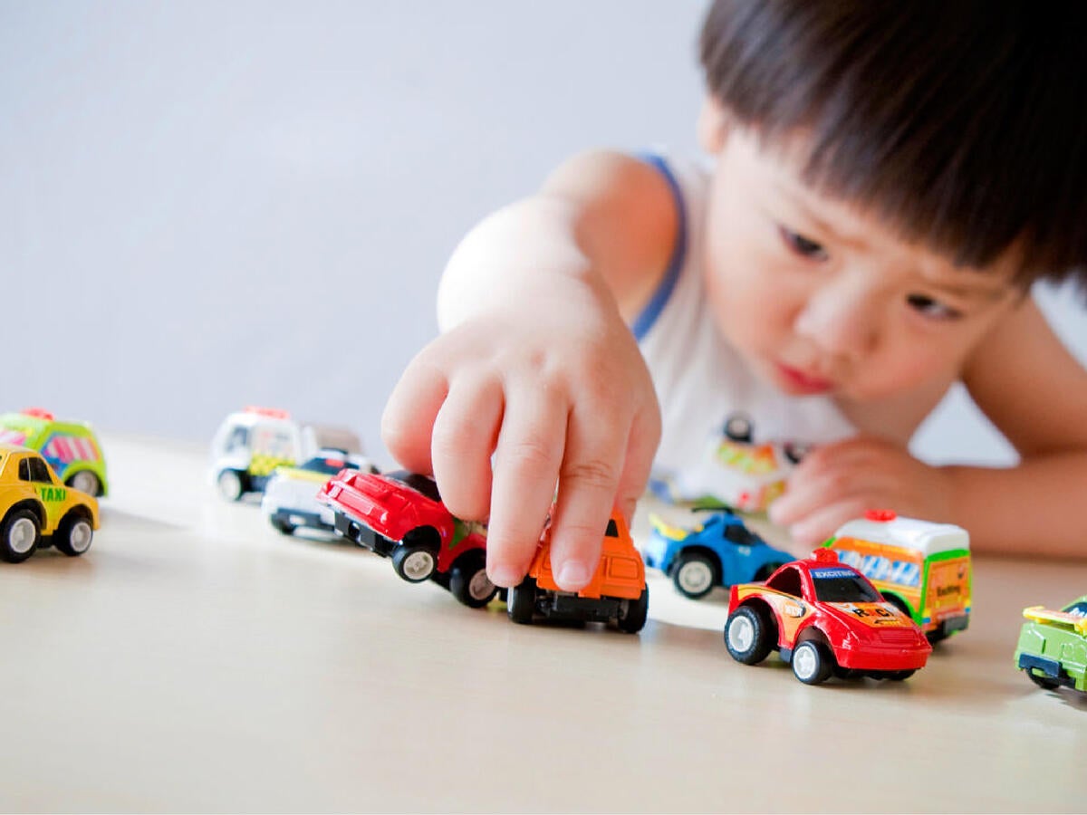 Boy playing with toy cars