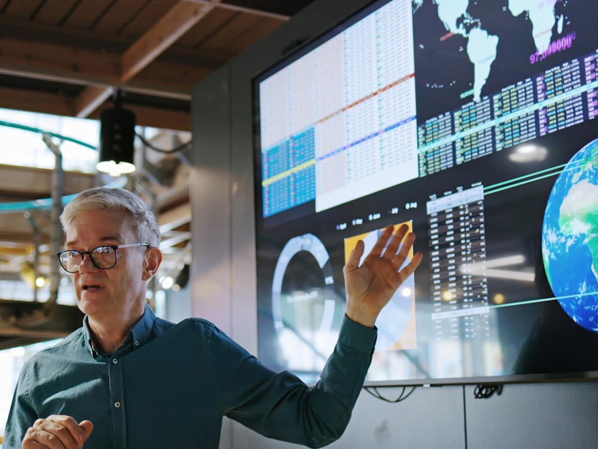 person showing hand to the screen while explaining