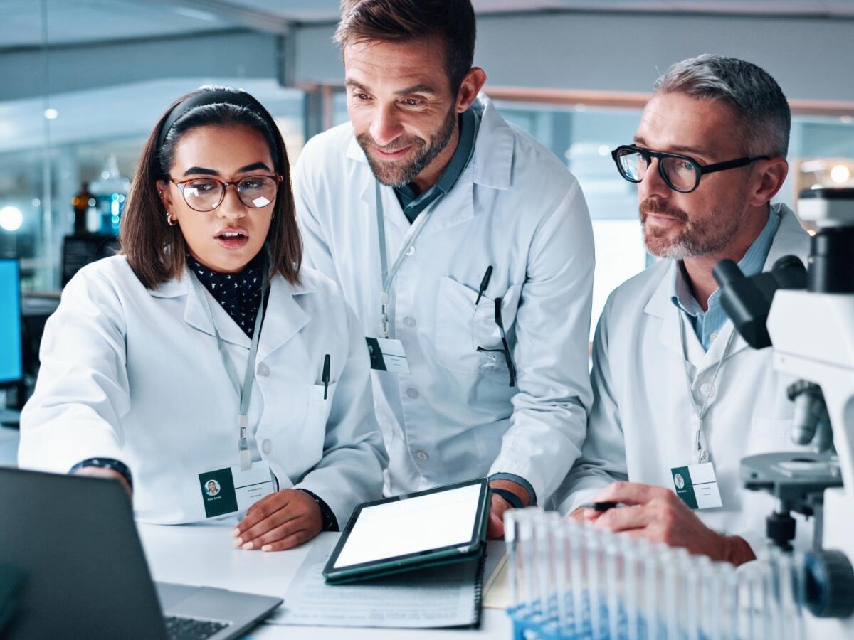  Close-Up of Team Reviewing Data on a Computer in Laboratory