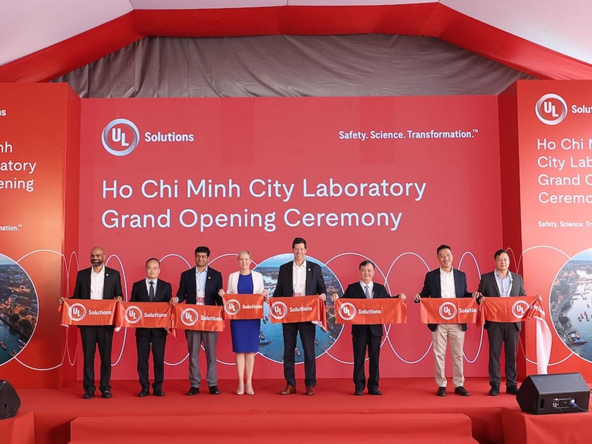 Business leaders cutting a ribbon at Vietnam facility