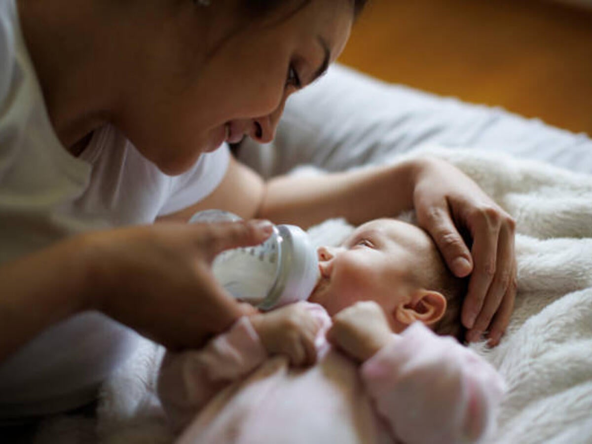 Mother feeding a baby with a bottle 