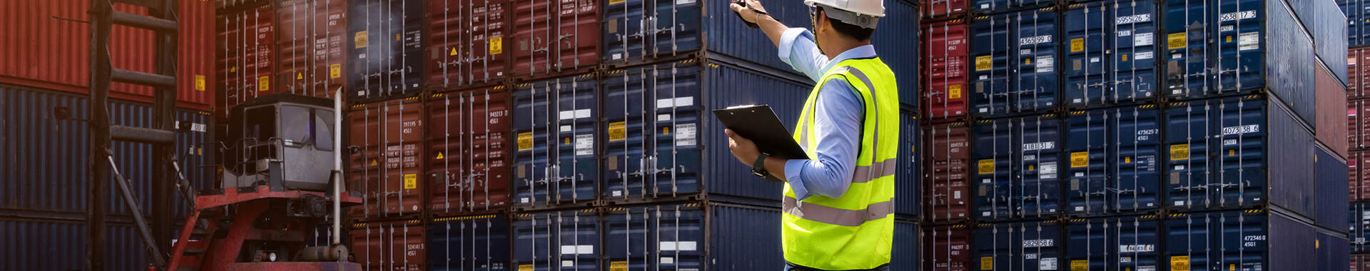 Worker pointing at Shipping Containers