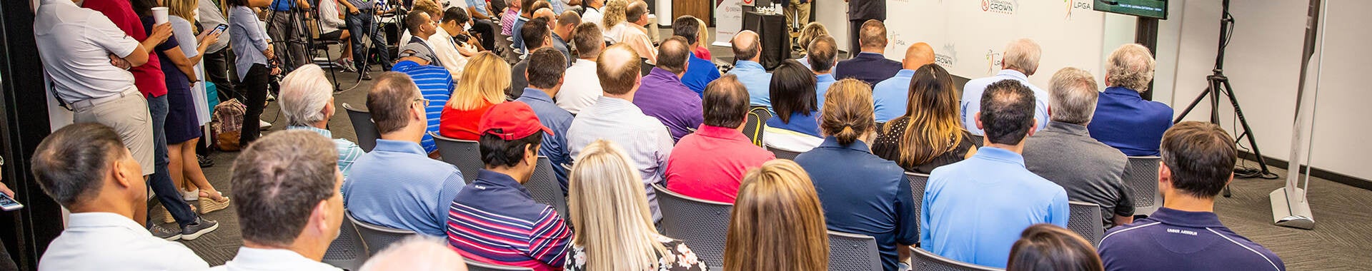 Photo of a crowd attending a presentation in a large view.