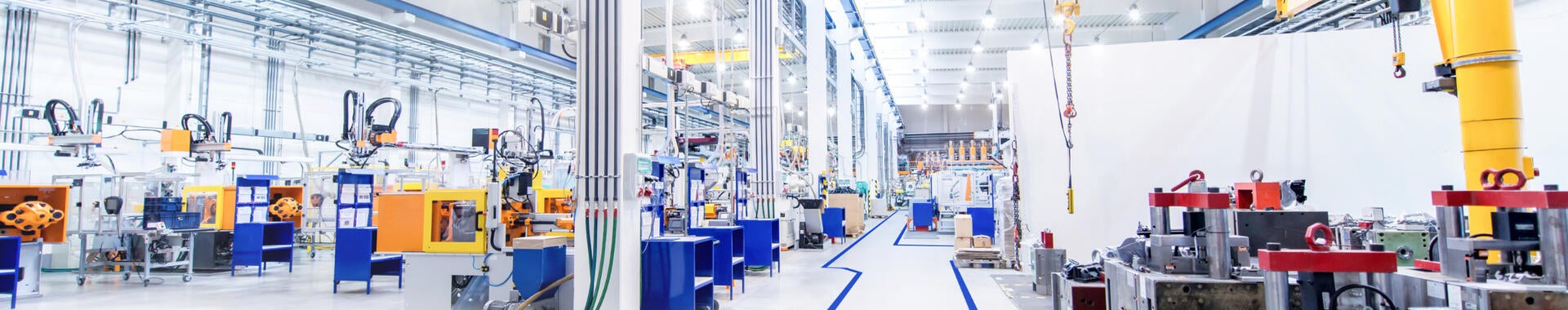 View overlooking the digitally controlled lighting of a brightly lit modern factory floor.