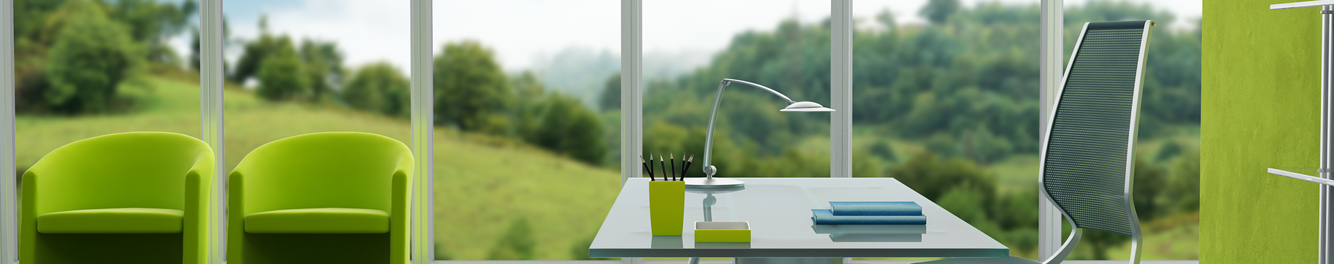 Glass desk with chair and view of the countryside through corporate windows.