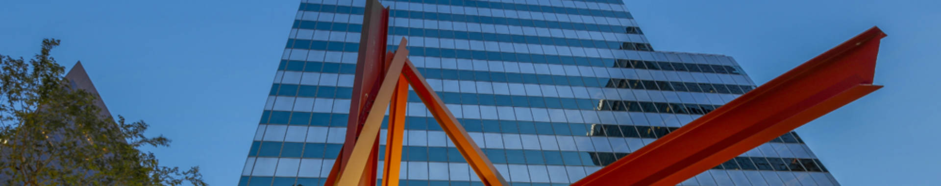 Skyscraper with red sculpture in the foreground