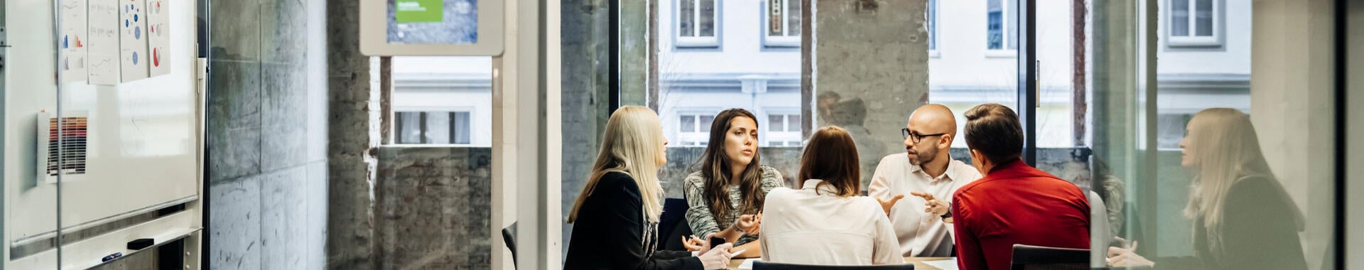 Several people talking around a meeting table