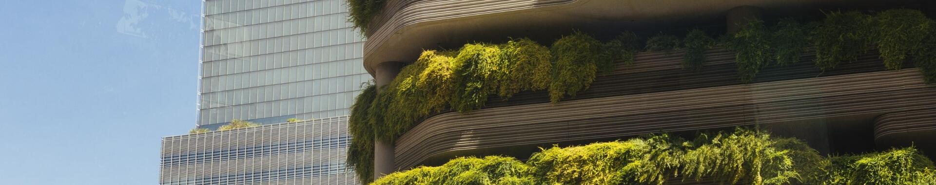 Urban high-rise apartment building with lush vertical garden.