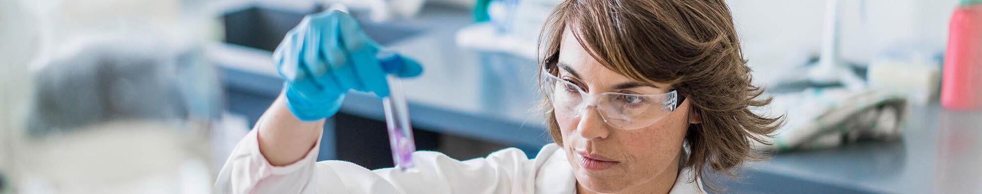 Scientist inspecting sample in a test tube