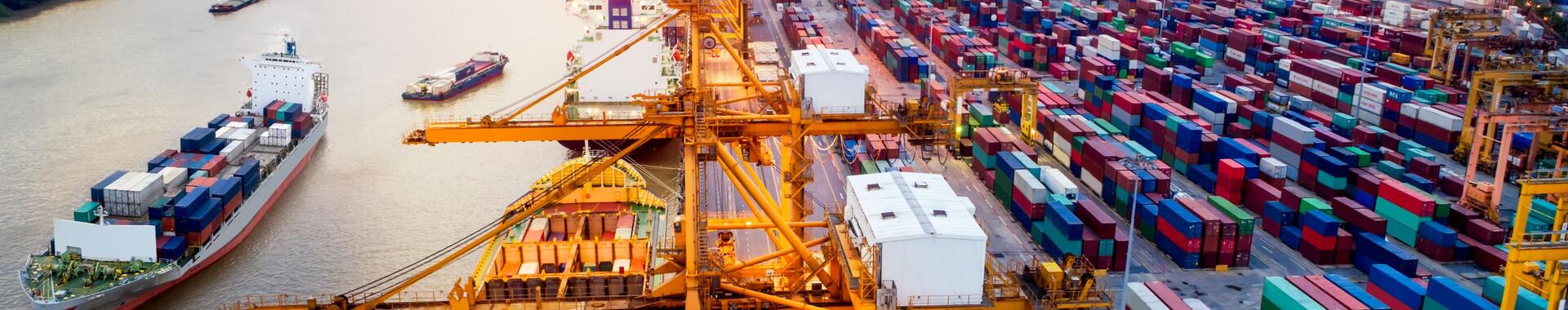 Logistics and transportation of Container Cargo ship and Cargo plane with working crane bridge in shipyard.