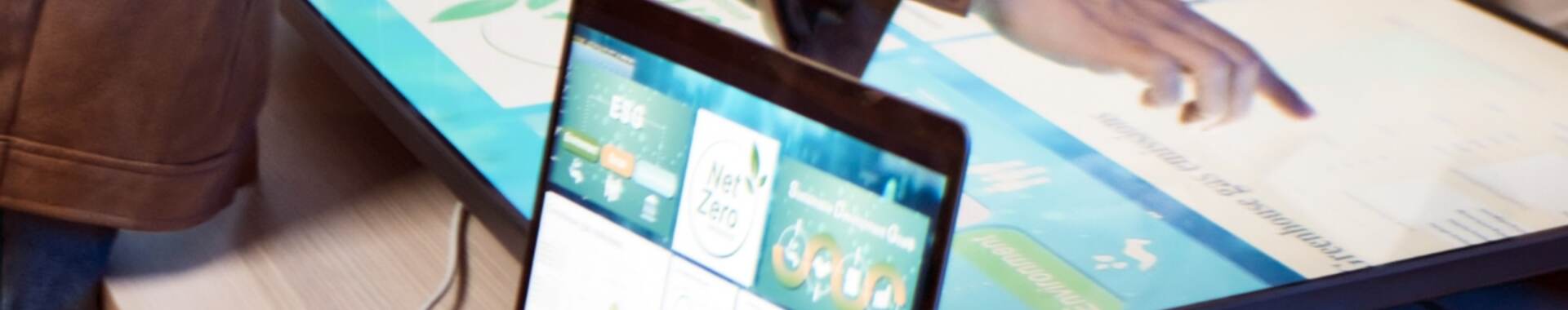 a person looking at net zero data on a laptop