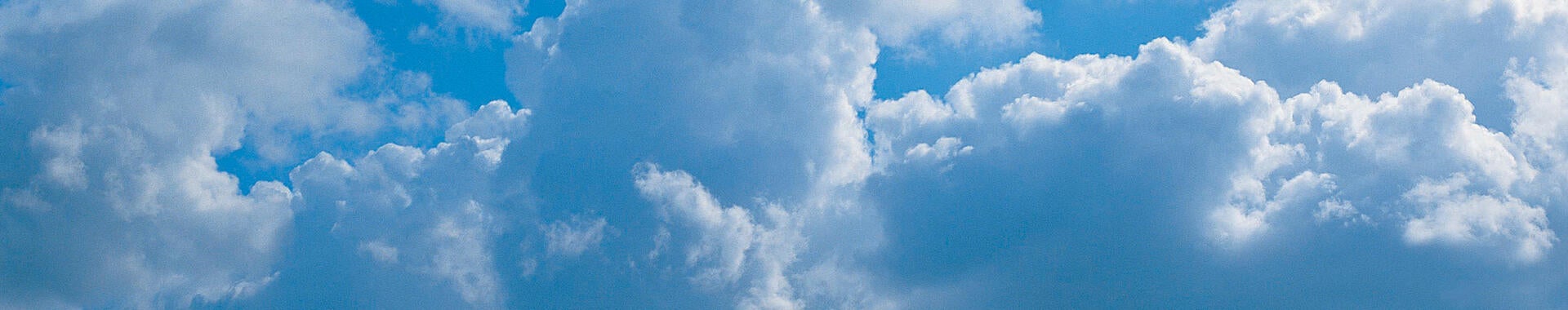 A blue sky with fluffy clouds