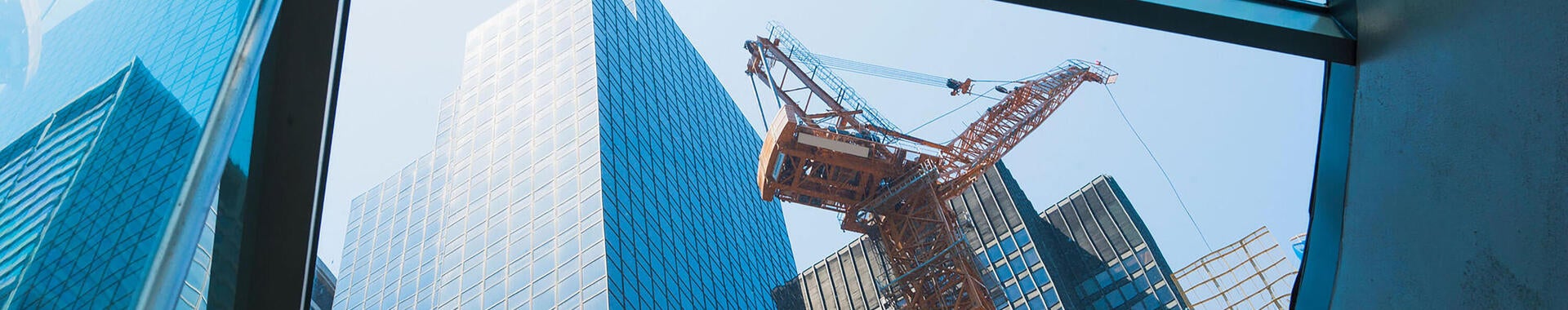 Building being constructed using a large crane