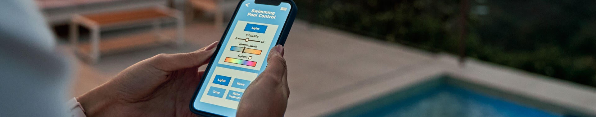 A person using a mobile device near a pool