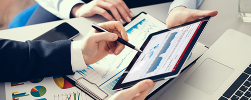 Image of two people’s hands holding a tablet, displaying Connect Analytics for Product iQ