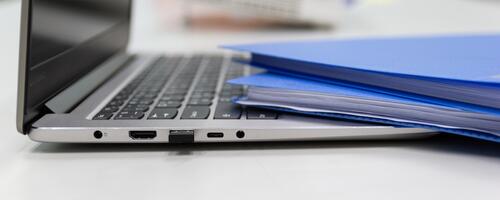 Folders and laptop on a desk.