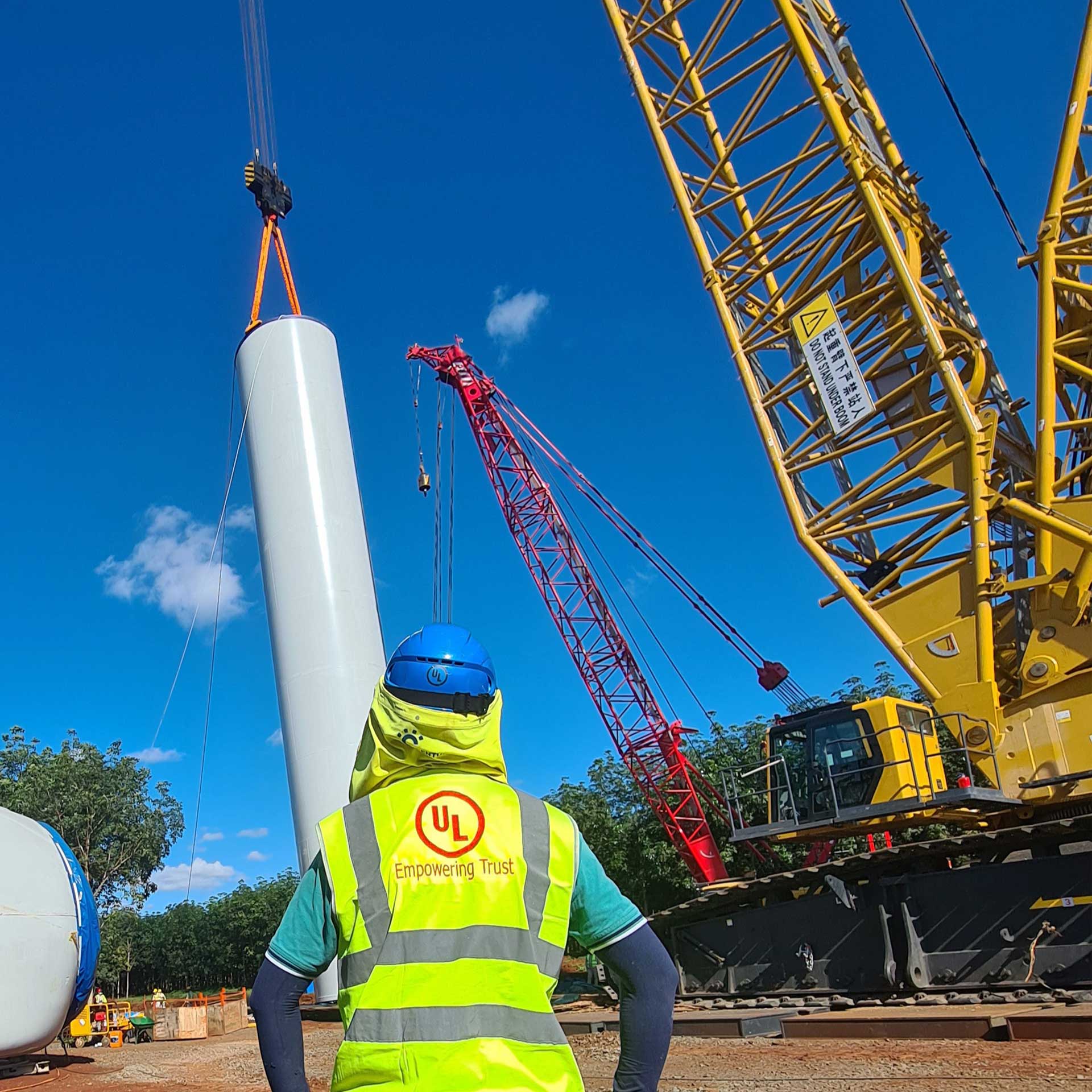 UL employee supervising set up of wind turbine