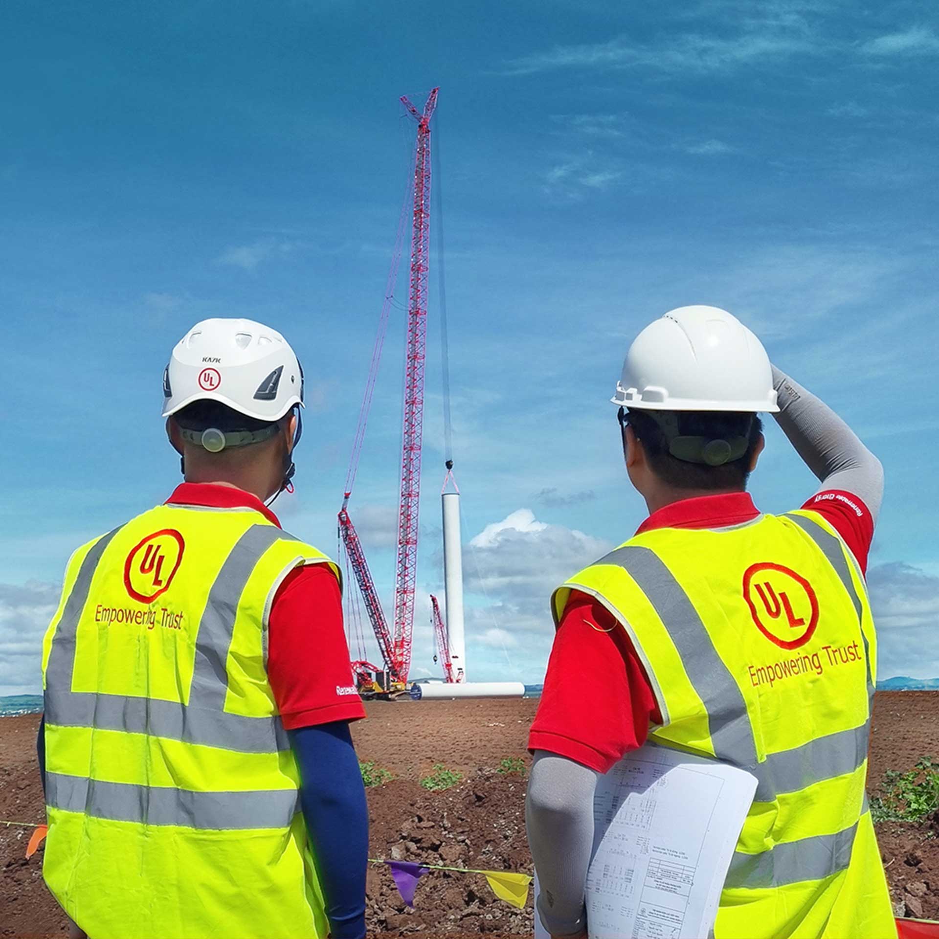two UL employees supervising wind turbine install