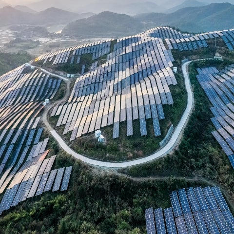 arial shot of solar panels spanning rolling hills