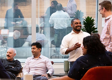 UL employees talking in open office space