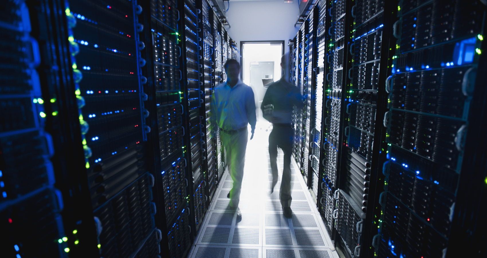People walking through a server room