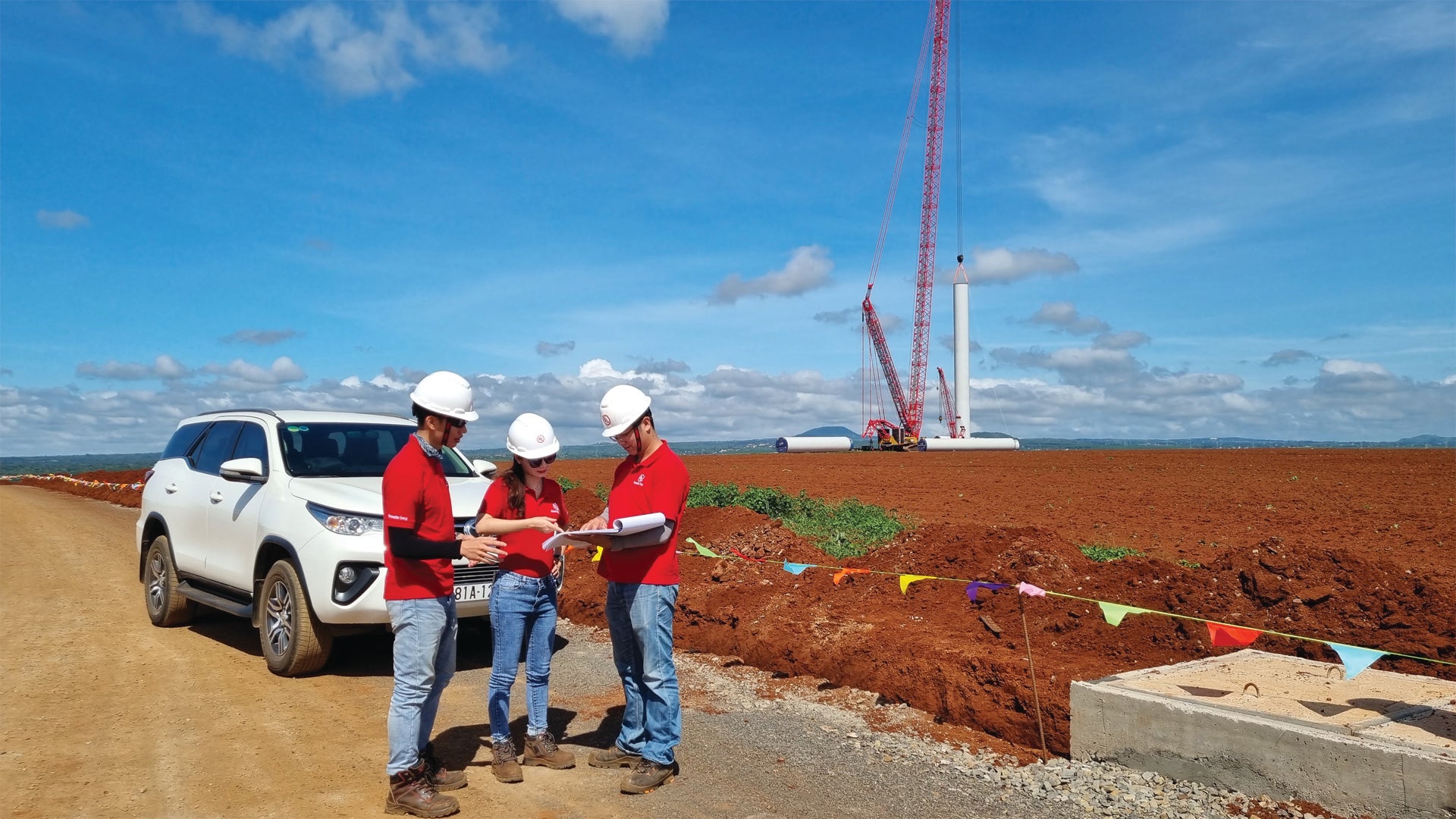 Workers out in the field monitoring site