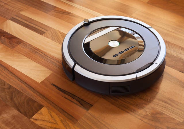 Robotic Vacuum cleaner on laminate wood floor smart cleaning technology