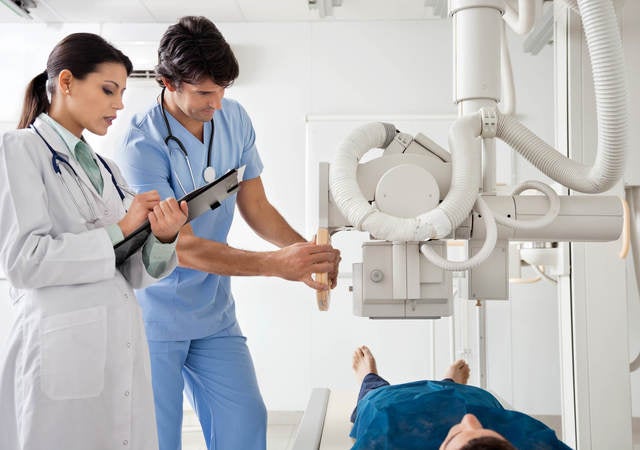 medical technician operating equipment