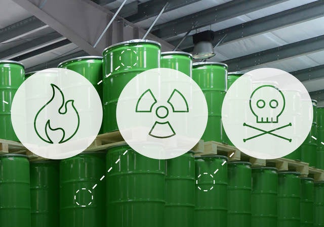 Stacks of barrels containing chemicals superimposed with safety hazard icons for European classification and labelling