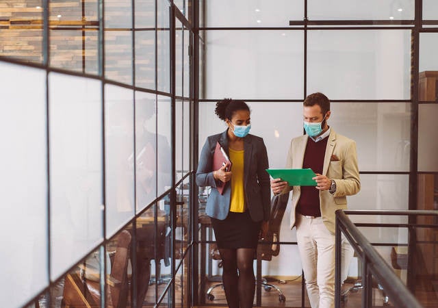 Colleagues wearing masks in the workplace