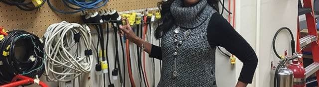 LeVette Martin stands before electrical equipment in UL lab