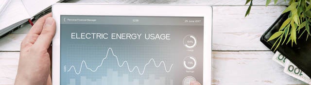 Man holds tablet PC with electric energy usage application