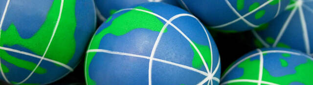 Close-up of squishy balls that look like the Earth. 