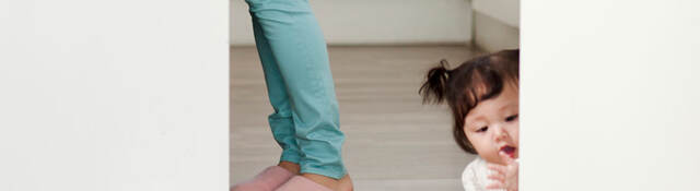 Child playing with toys on the kitchen floor.  
