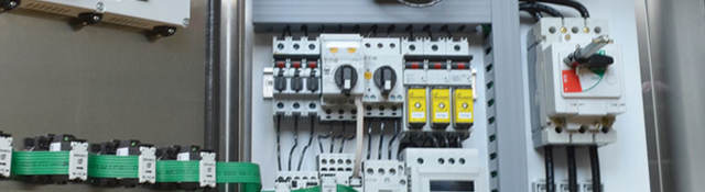 An opened industrial control panel showing components