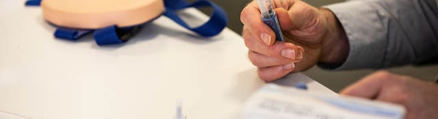 Practitioner holding injection product