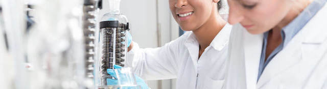 Group of scientists working with gloves and gowns in laboratory.