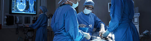 Surgeons with  a patient in an operating room