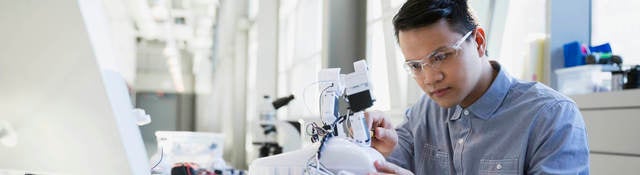 Worker working on a small robot