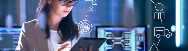 Photo of a woman in a lab working on a tablet