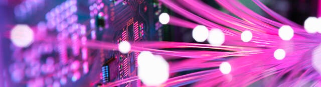 Pink colored fiber spreading into an electronic circuit board