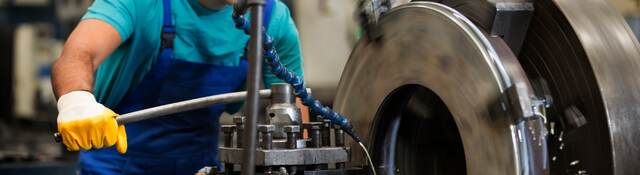 Man using metal cutting machine in factory