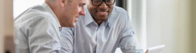 business men looking at tablet