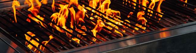 Barbecue gas grill with flames coming up 