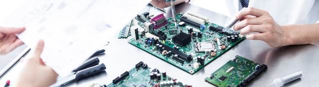 Lab tech working on electronic device