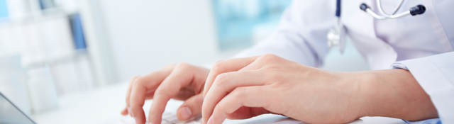Doctor typing on a laptop