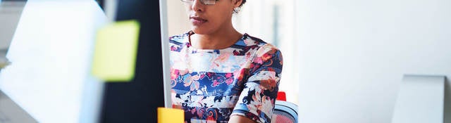 Woman reading news on computer screen