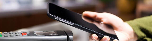 Mobile phone over a terminal being used for a contactless payment 