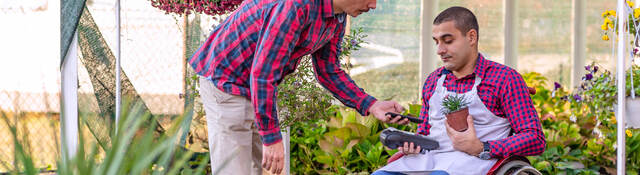 man paying with a mobile phone in flower shop