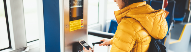 woman holding a mobile phone in front of the reader